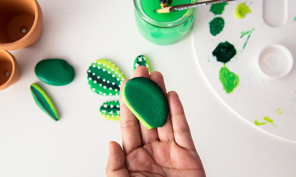 Painting cactus on stones